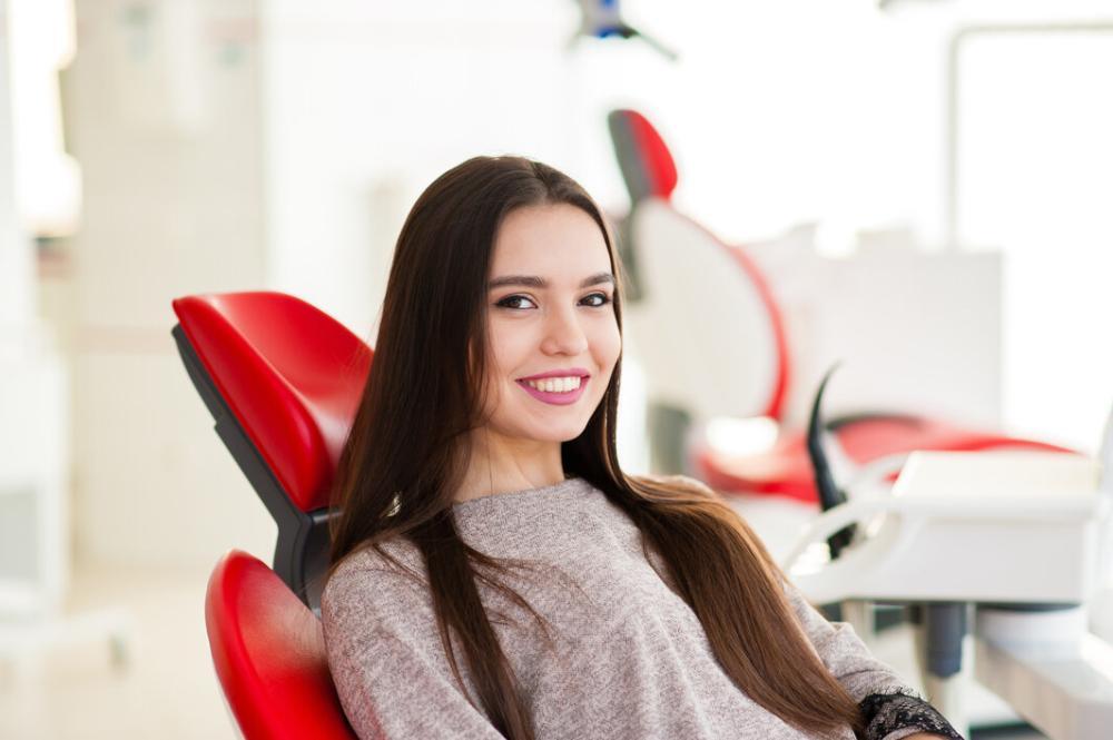 woman smiling in dental chair after exam