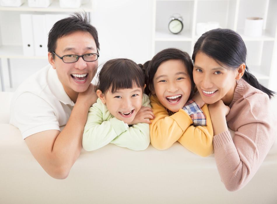 family of four smiling 