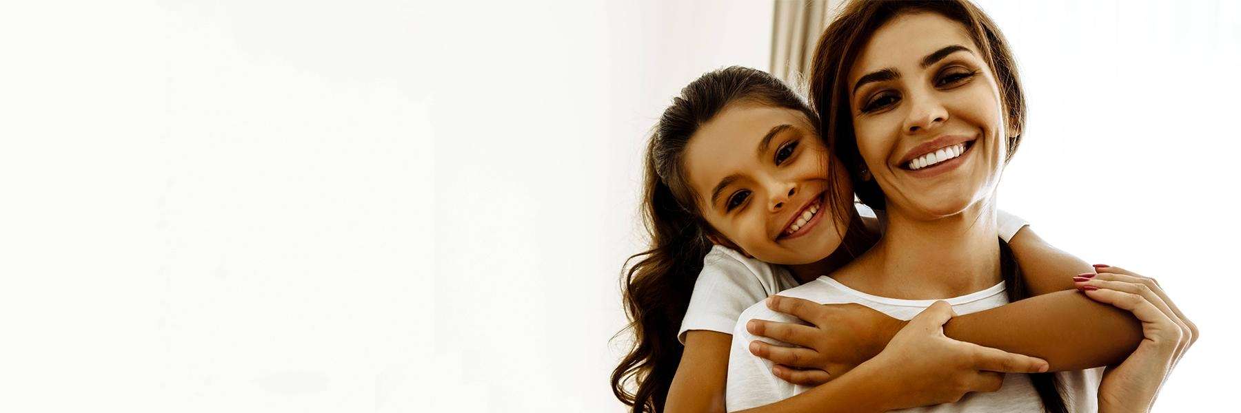 woman and daughter smiling 