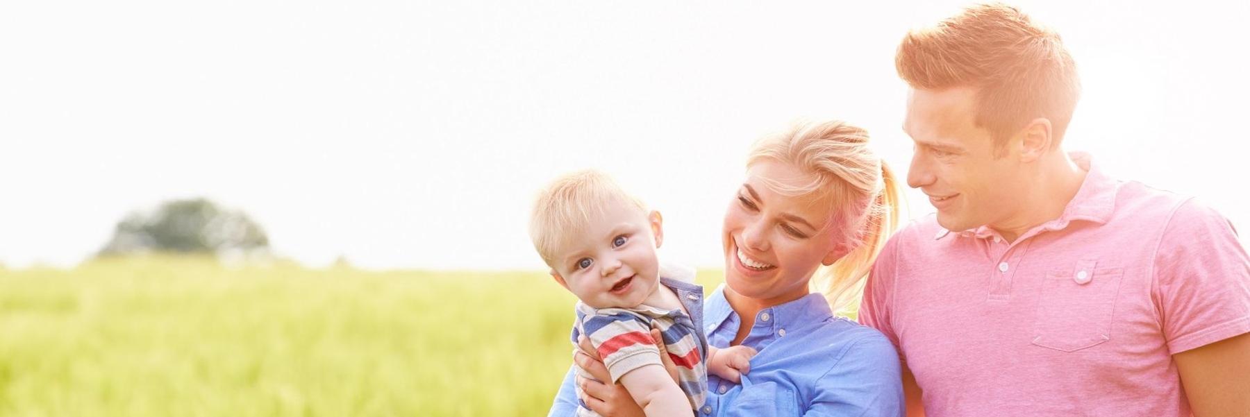 Mother, father, and baby smiling 