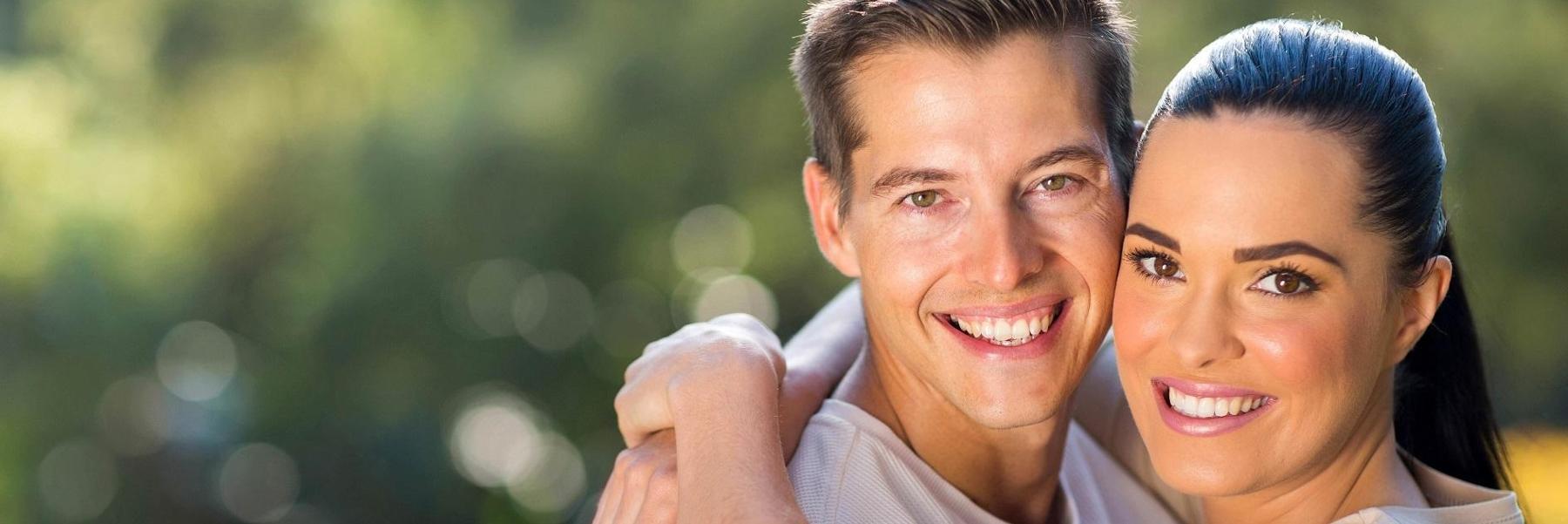 male and female couple hugging and smiling